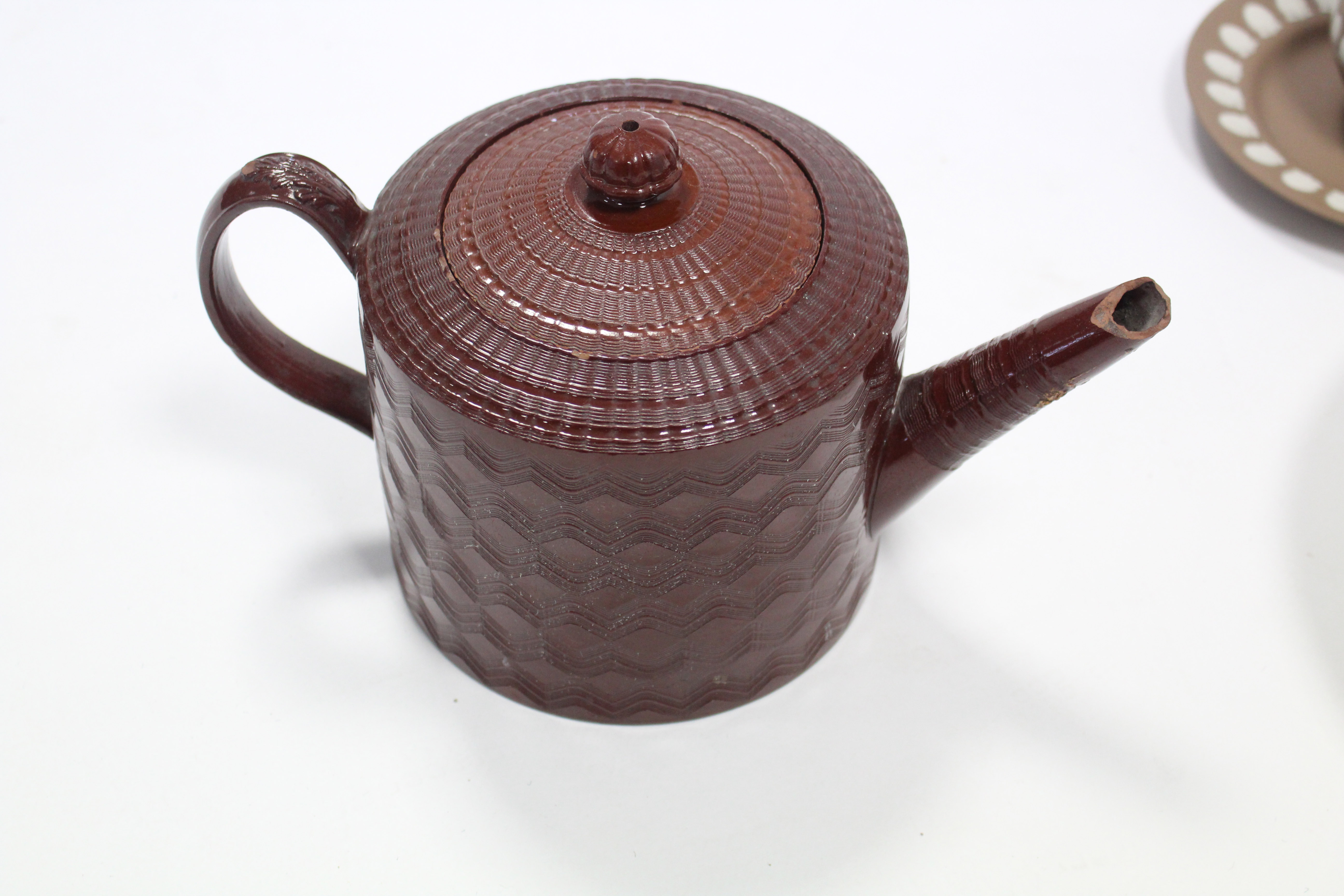 A late 18th/early 19th century Staffordshire Redware teapot with engine turned decoration (spout