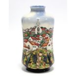 A Moorcroft pottery “Andalucia” vase designed by Beverley Wilkes, decorated with fruiting vines
