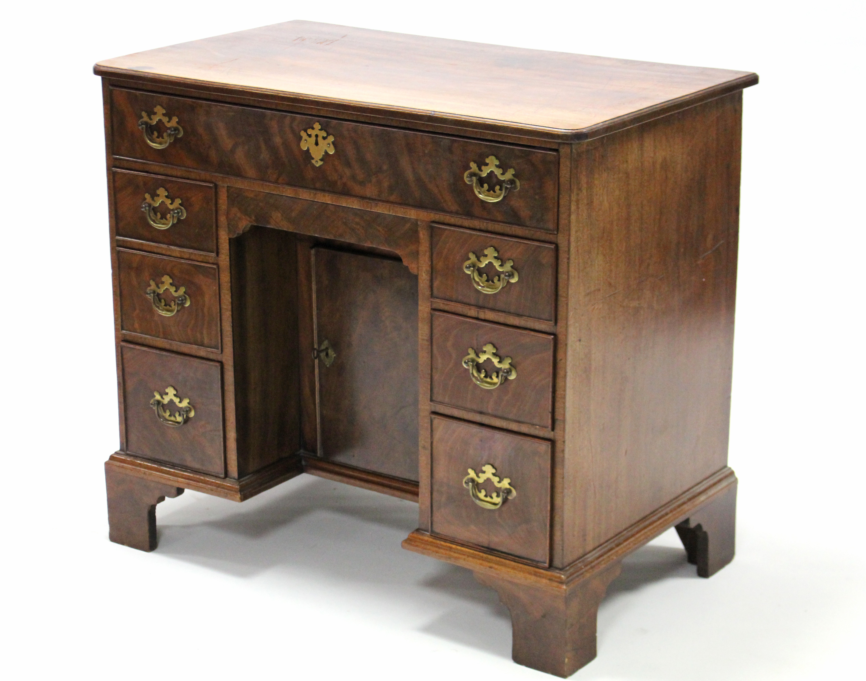 A George III style mahogany kneehole desk by Christopher Alexander, fitted an arrangement of seven