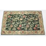A Kashmiri hook-stitch rug of Aubusson design, with central foliate panel within floral border;