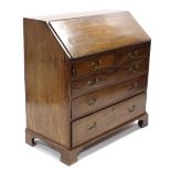 A late 18th century mahogany bureau, with fall-front enclosing fitted interior above two short &