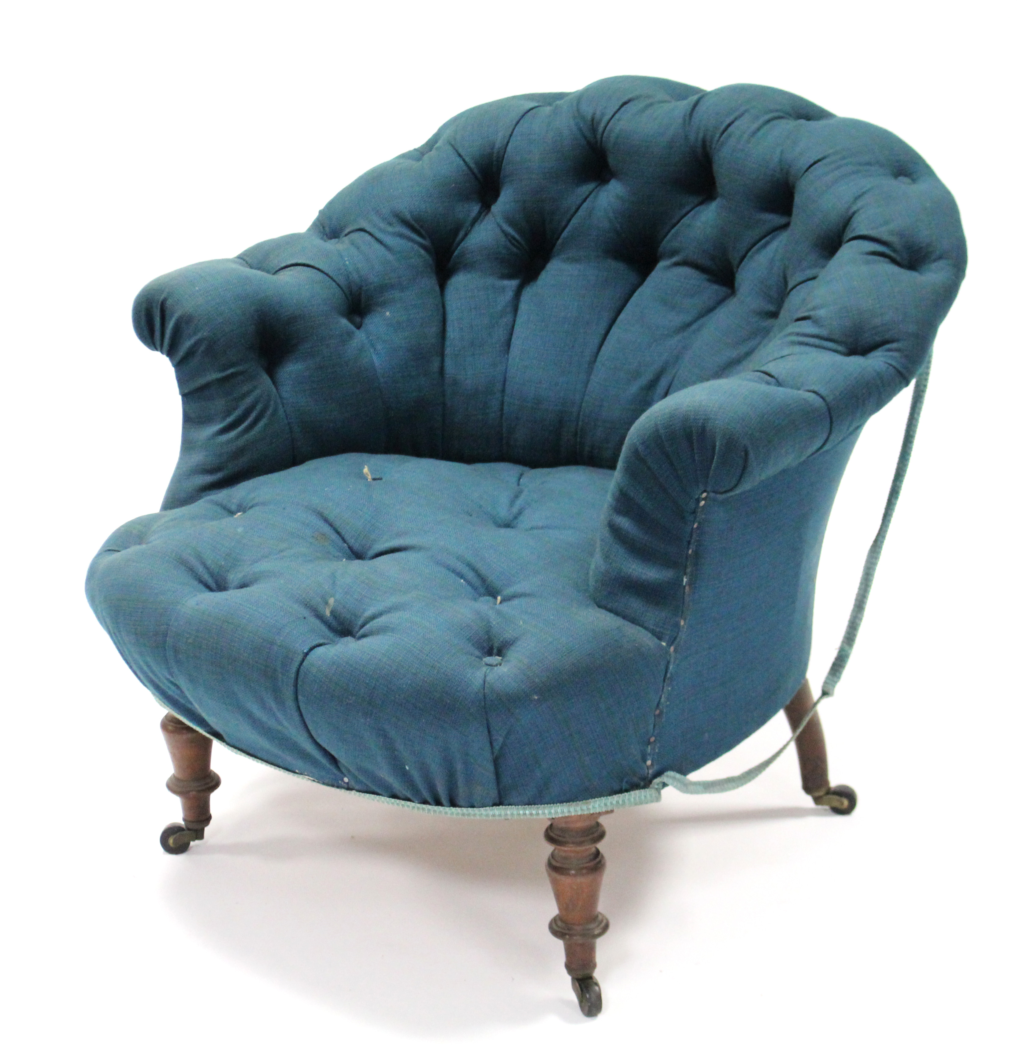 A Victorian armchair with buttoned seat & back upholstered dark blue material, on short vase-