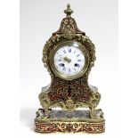 A late 19th century French mantel clock in Louis XVI style rococo ebonised case with Boulle &