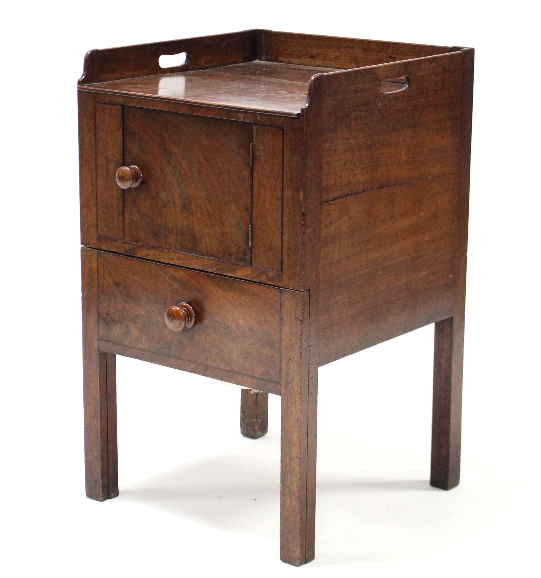 A 19th century mahogany tray-top bedside commode, the panel door & pull-out seat with turned knob