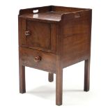 A 19th century mahogany tray-top bedside commode, the panel door & pull-out seat with turned knob