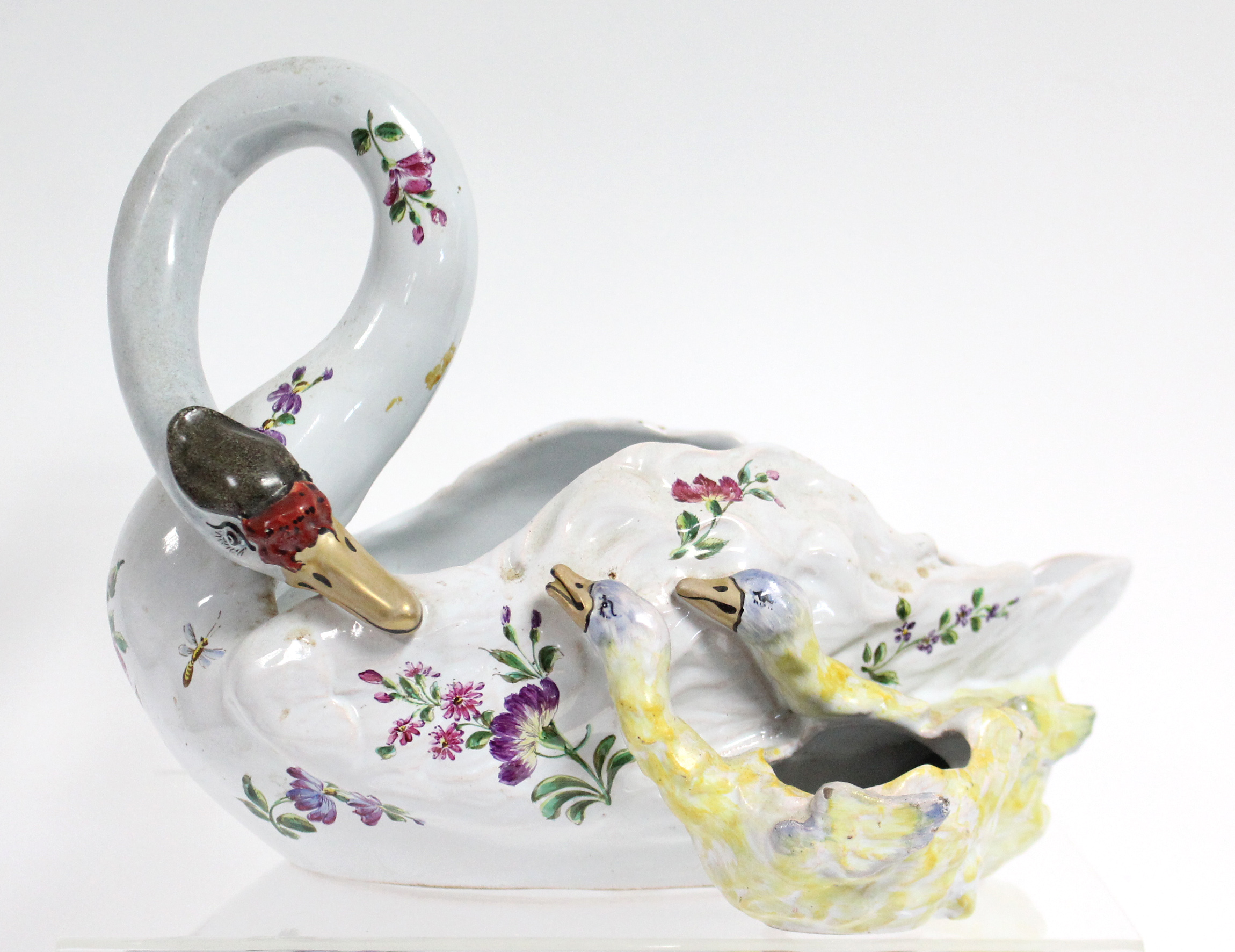 A GALLÉ FAIENCE BOWL IN THE FORM OF A SWAN, its neck looped downwards toward two cygnets at her