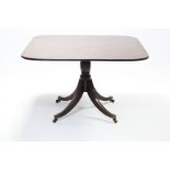 A Regency figured mahogany breakfast table, the rectangular tilt-top with rounded corners & reeded