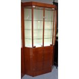 Another modern mahogany-finish upright illuminated shop display cabinet with canted sides, fitted