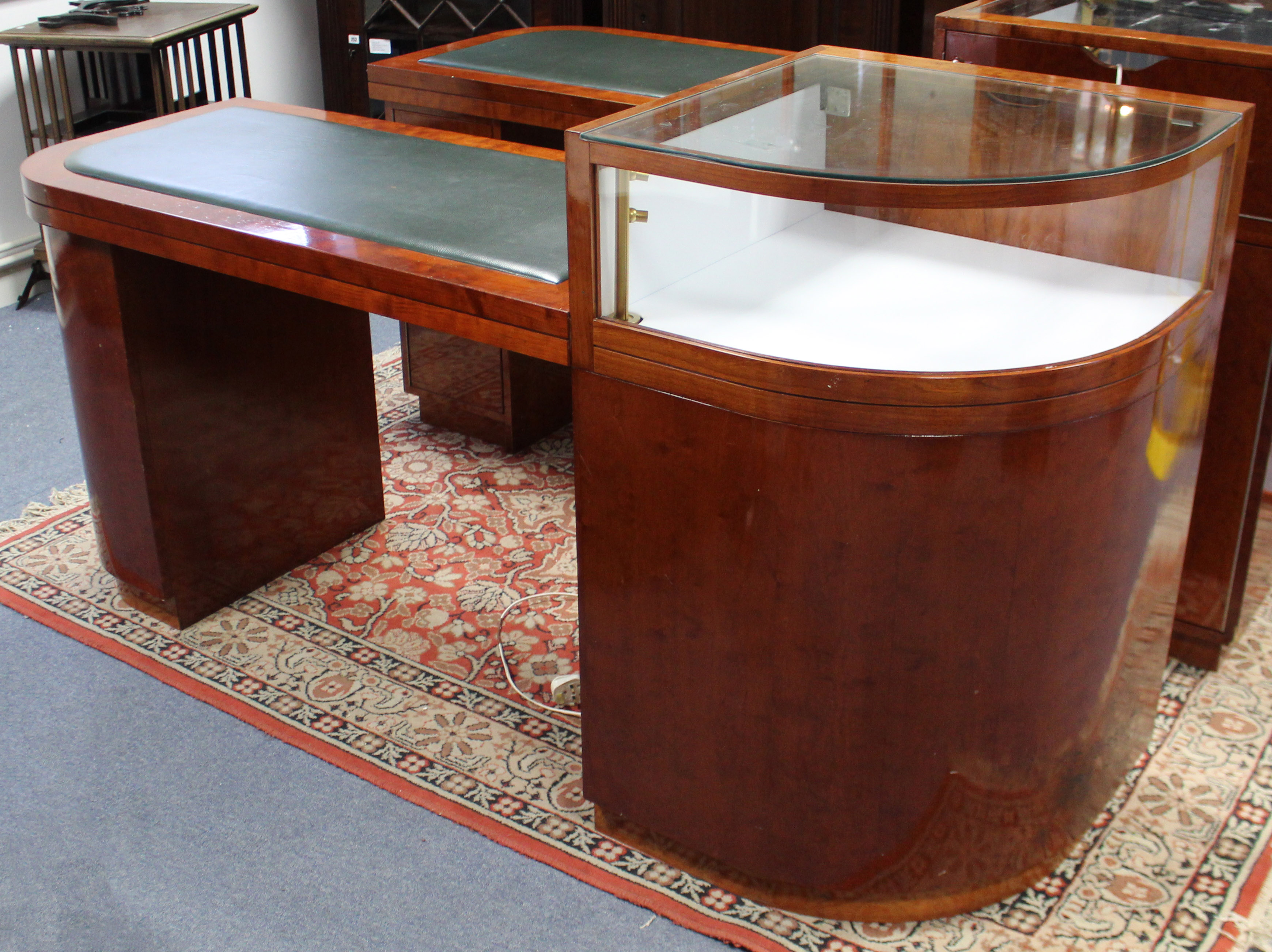 Another modern mahogany-finish pedestal desk/display cabinet with D-shaped ends & inset