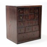 An 18th century mahogany spice cabinet fitted an arrangement of sixteen small drawers with brass
