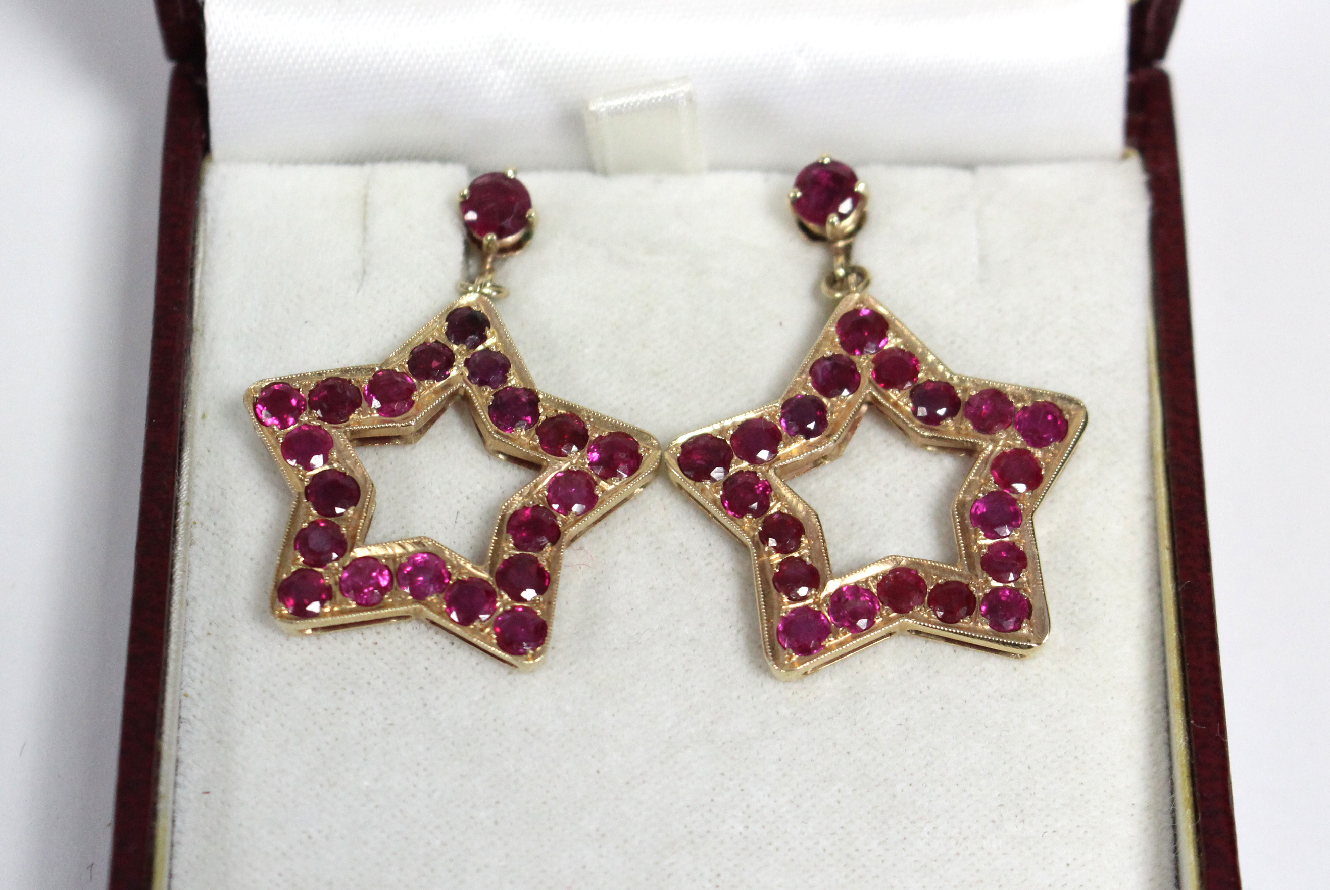 A PAIR OF RUBY PENDANT EARRINGS, each of open five-pointed star shape, set twenty round-cut stones - Image 4 of 6