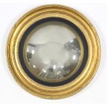 A Regency-style gilt frame convex wall mirror, with reeded ebonised inner slip; 27” diam.