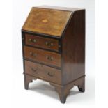 A 19th century small inlaid-mahogany bureau, the sloping fall-front with marquetry shell enclosing