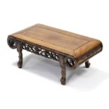 A Chinese hardwood low occasional table with scroll-shaped ends, carved & pierced frieze, with