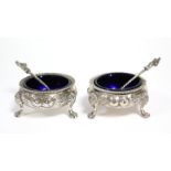 A pair of Victorian silver salt cellars of compressed circular form, with gadrooned rims & raised