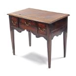 An 18th century mahogany lowboy, fitted three frieze drawers with brass handles above a shaped