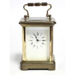 A French brass-cased small carriage timepiece, the white enamel dial with black roman numerals &