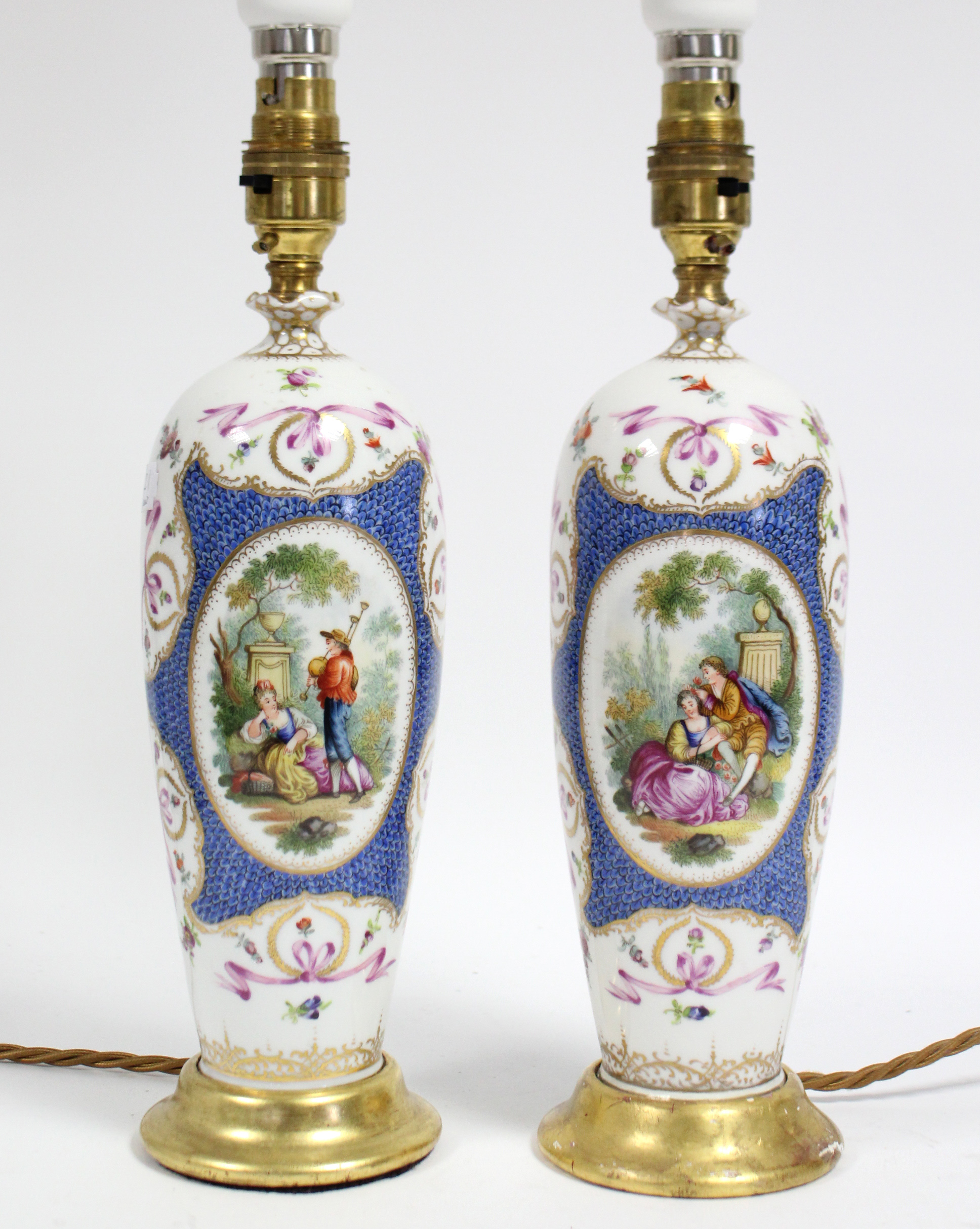 A pair of Dresden porcelain slender ovoid vases decorated with romantic figure scenes on a blue-