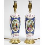 A pair of Dresden porcelain slender ovoid vases decorated with romantic figure scenes on a blue-