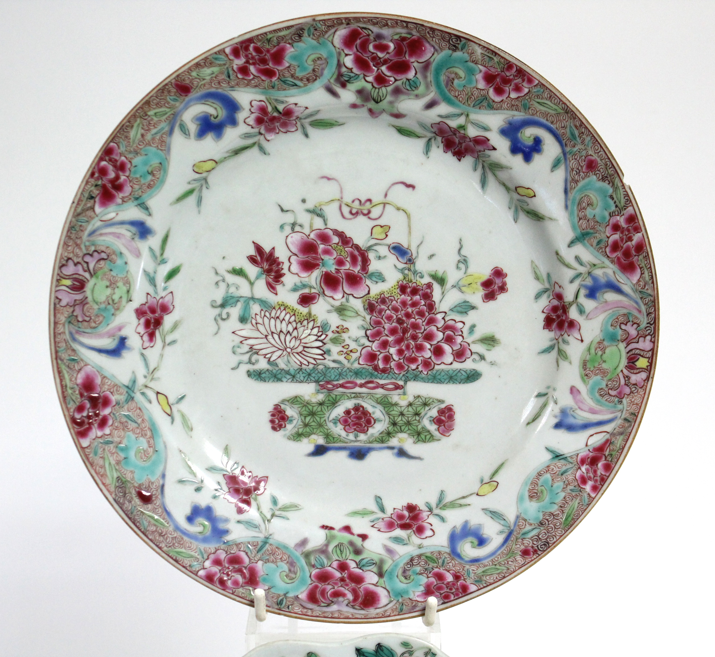 Four 18th century Chinese porcelain plates, variously painted with exotic flowers in famille rose