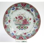 Four 18th century Chinese porcelain plates, variously painted with exotic flowers in famille rose