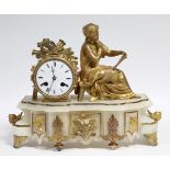 A mid-19th century French mantel clock in gilt-metal figural case, the 3¼” white enamel dial with