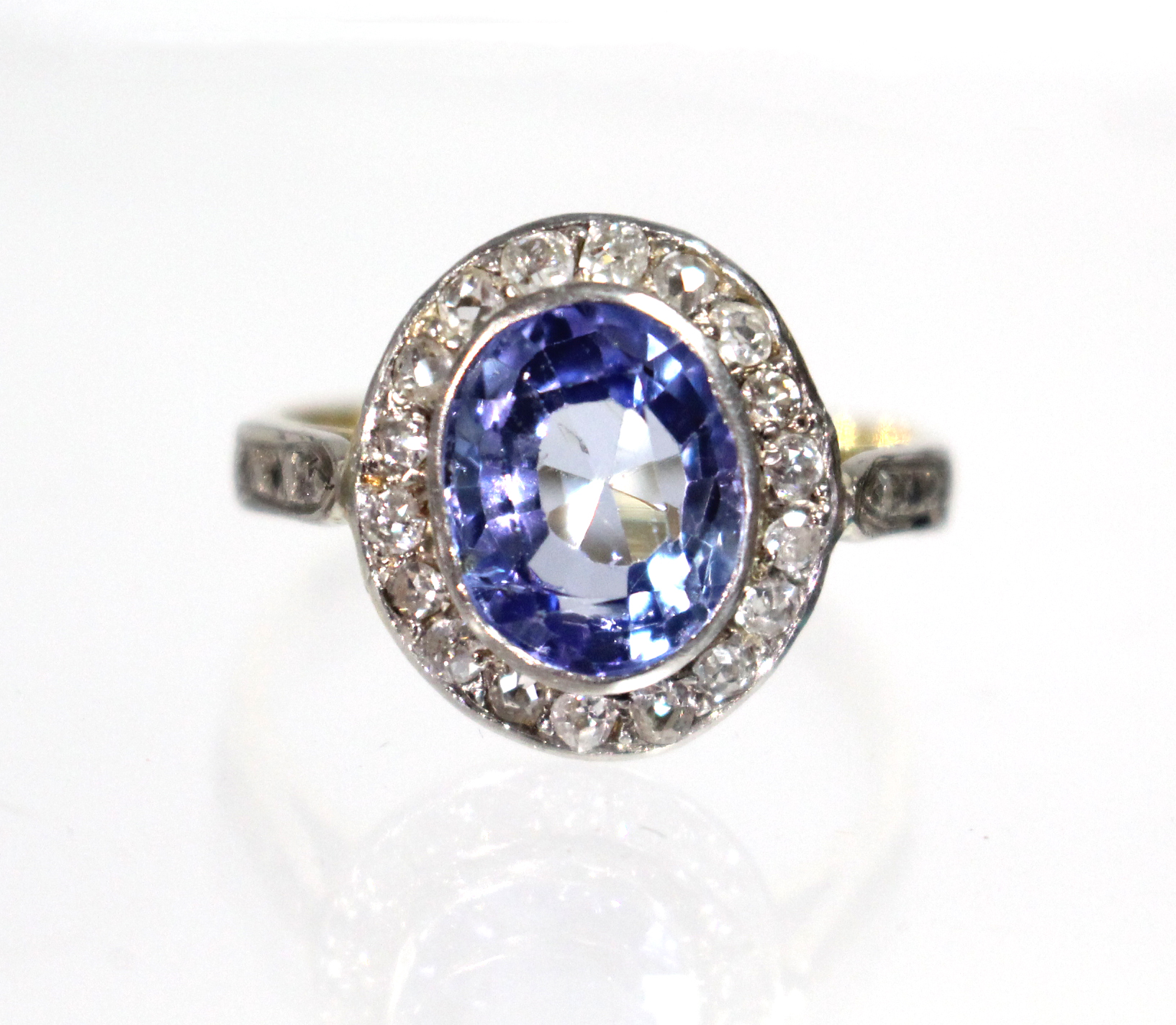 A Ceylon sapphire & diamond ring, the oval sapphire measuring approx. 9.5mm x 8mm, set within a