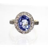 A Ceylon sapphire & diamond ring, the oval sapphire measuring approx. 9.5mm x 8mm, set within a