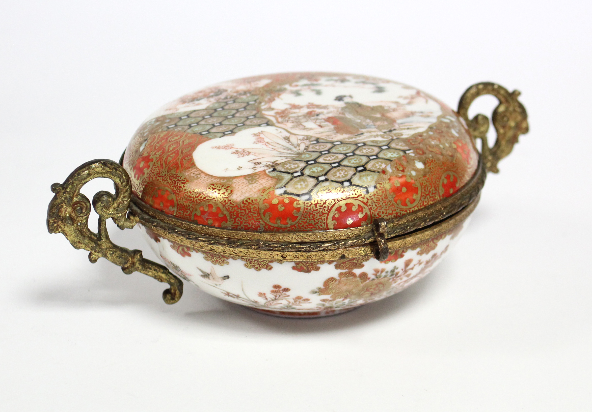 A 19th century Japanese Kutani porcelain circular box & cover decorated with figure scenes, flowers,