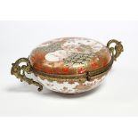 A 19th century Japanese Kutani porcelain circular box & cover decorated with figure scenes, flowers,