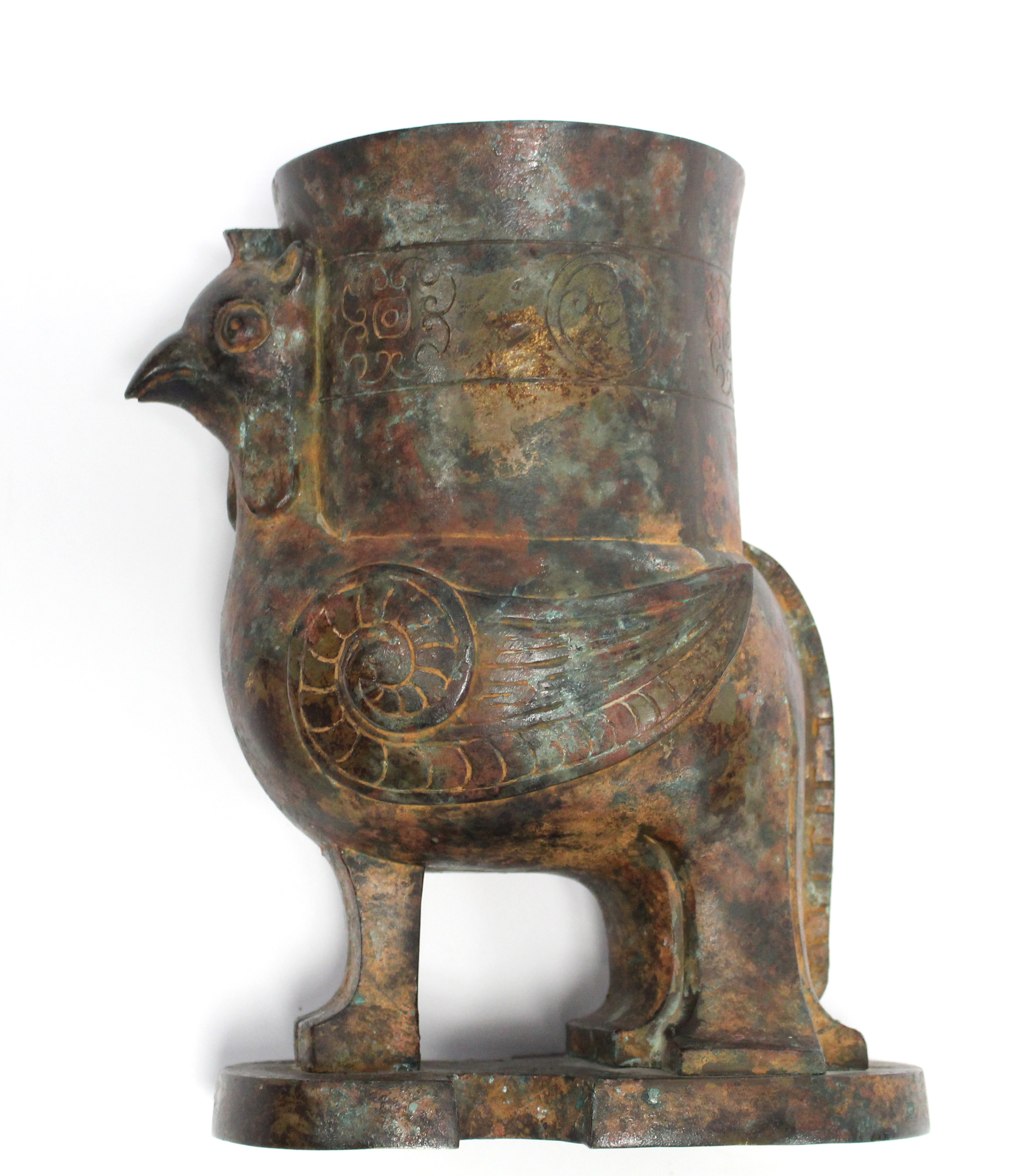 A CHINESE BRONZE ARCHAISTIC PHOENIX VESSEL, the bird supporting a cylindrical vase on its back, with