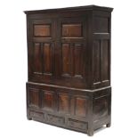 A LATE 17th century JOINED OAK TALL CUPBOARD, the upper part with moulded cornice & enclosed by a