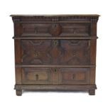 A LATE 17th century OAK CHEST, with carved frieze & applied geometric mouldings, fitted three long