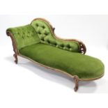A Victorian carved mahogany chaise longue with serpentine front, pierced foliate back, upholstered