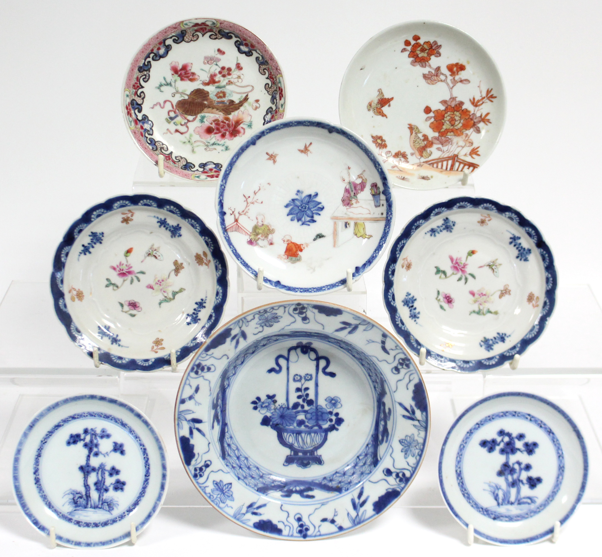 A pair of 18th century Chinese blue-&-white porcelain “Nanking Cargo” saucers painted with pine