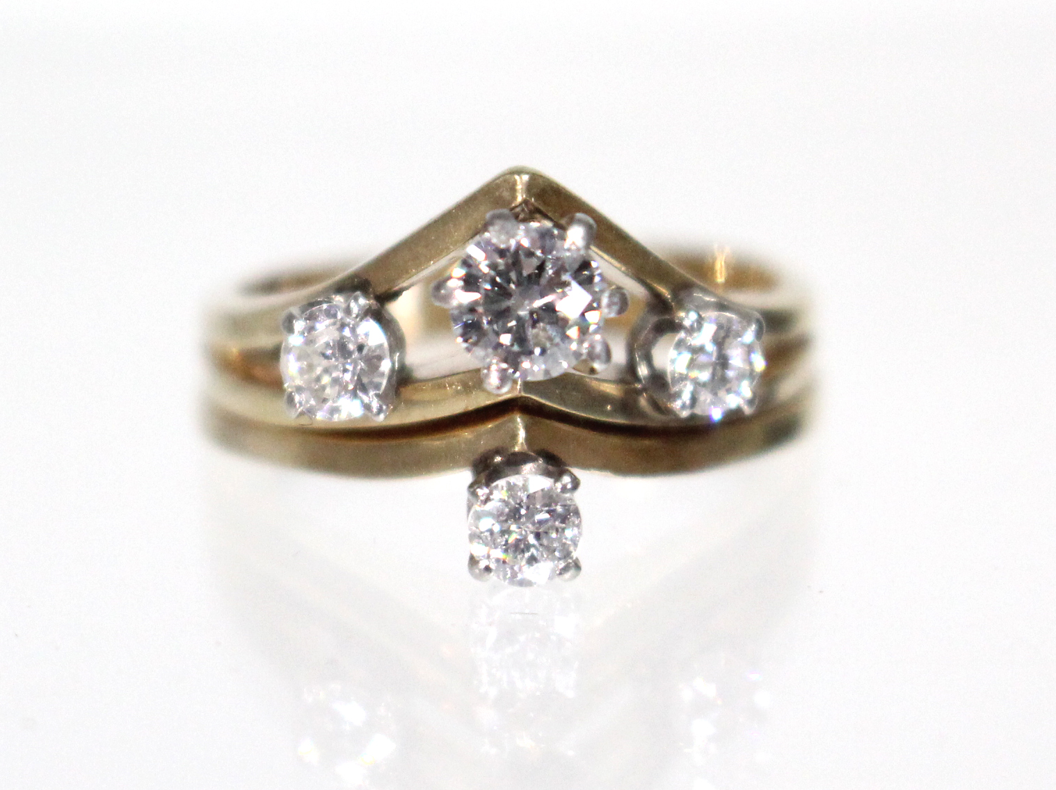 A diamond ring, the four graduated stones set in a tiered arrangement, the largest approx. 0.25