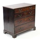 A late 18th century oak chest of four long graduated drawers with brass swan—neck handles, & on