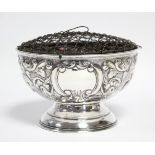An Edwardian silver rose bowl with embossed leaf-scroll decoration, 6” diam.; Chester 1903, by