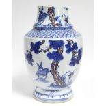 A Chinese porcelain tall ovoid vase with underglaze blue & overglaze copper-red decoration of deer &