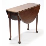 A Georgian mahogany drop-leaf supper table, with circular top on slender turned legs with pad