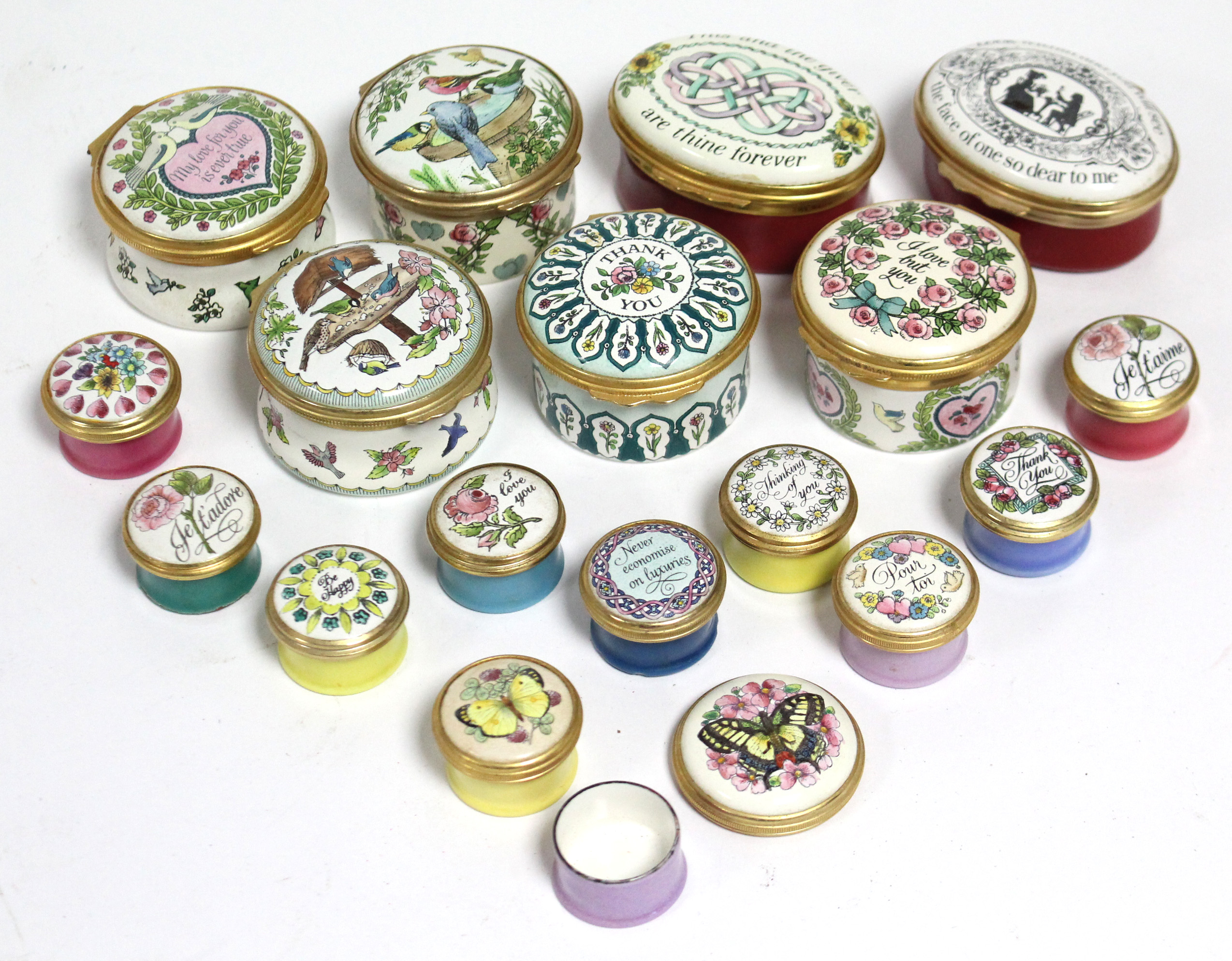 A collection of seventeen Halcyon Days decorated enamel small boxes of various shapes & sizes; &