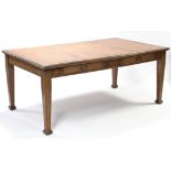 An early 20th century oak partner’s writing table, the rectangular top with moulded edge, inset gilt