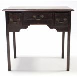 A late 18th century oak lowboy with rectangular top, fitted three frieze drawers & on square