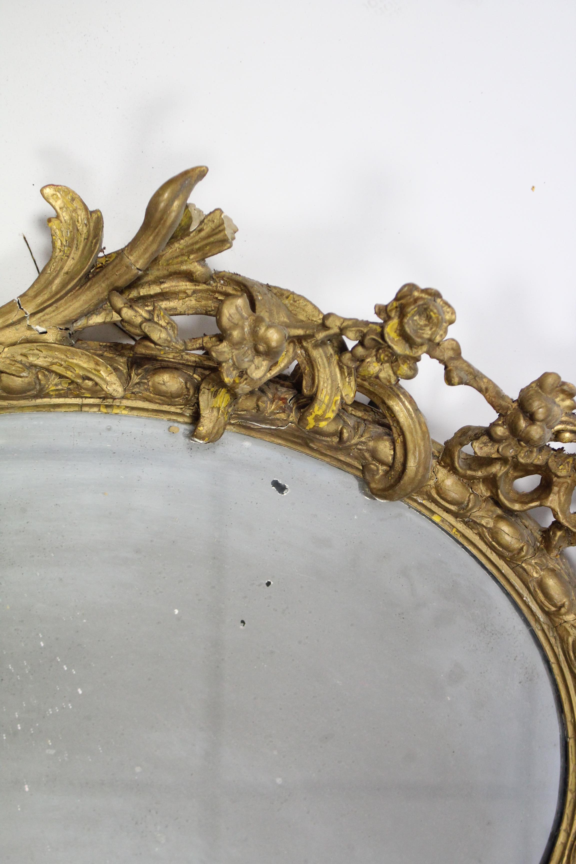 An early 19th century girandole, the oval mirror plate in gilt gesso rococo frame with floral - Image 4 of 5