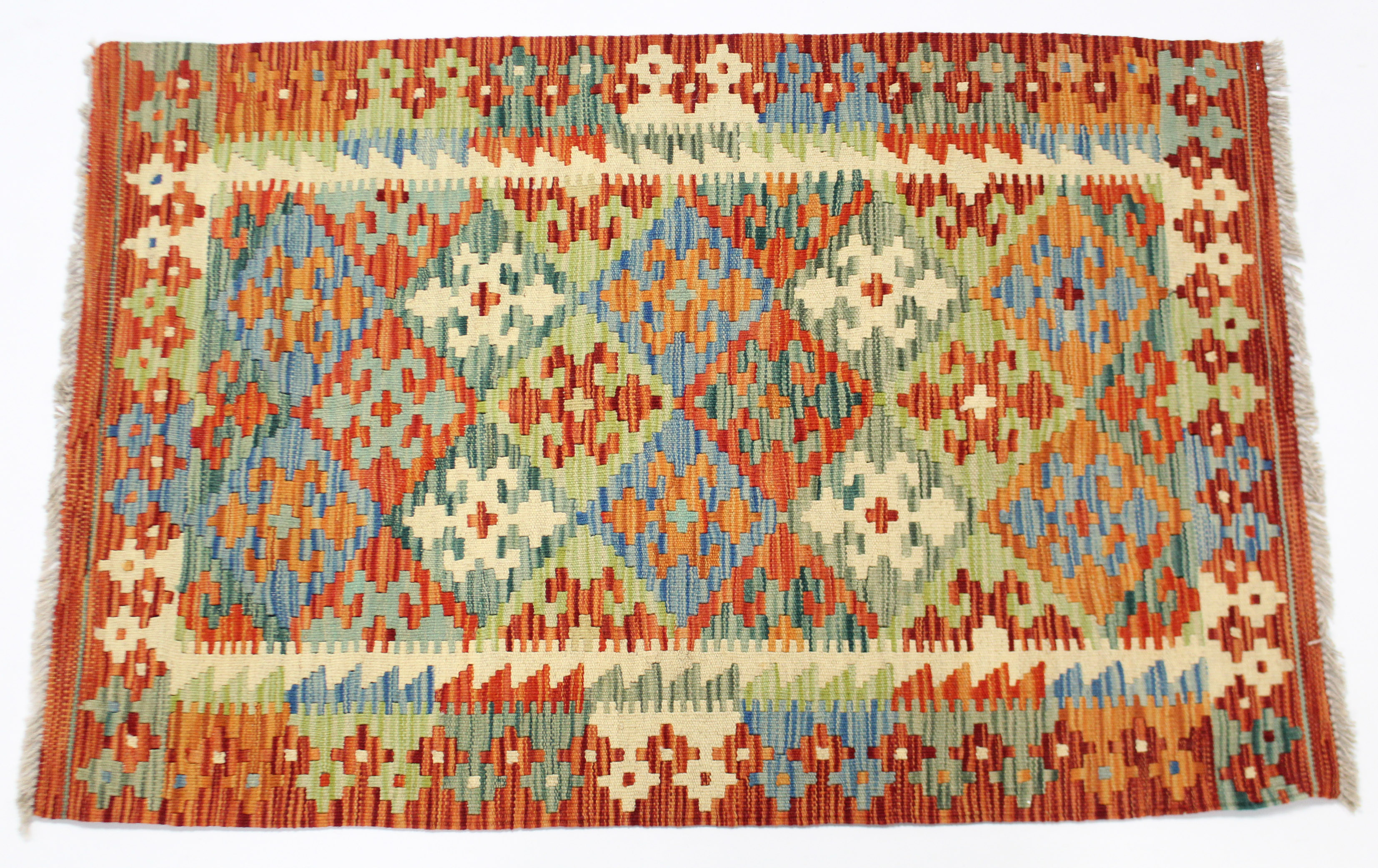 A vegetable-dye kelim rug with multi-coloured geometric lozenge design & wide border; 31” x 48”.