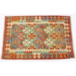 A vegetable-dye kelim rug with multi-coloured geometric lozenge design & wide border; 31” x 48”.
