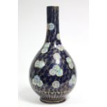 A 19th century Chinese porcelain ovoid vase with tall narrow neck, decorated with scattered roundels