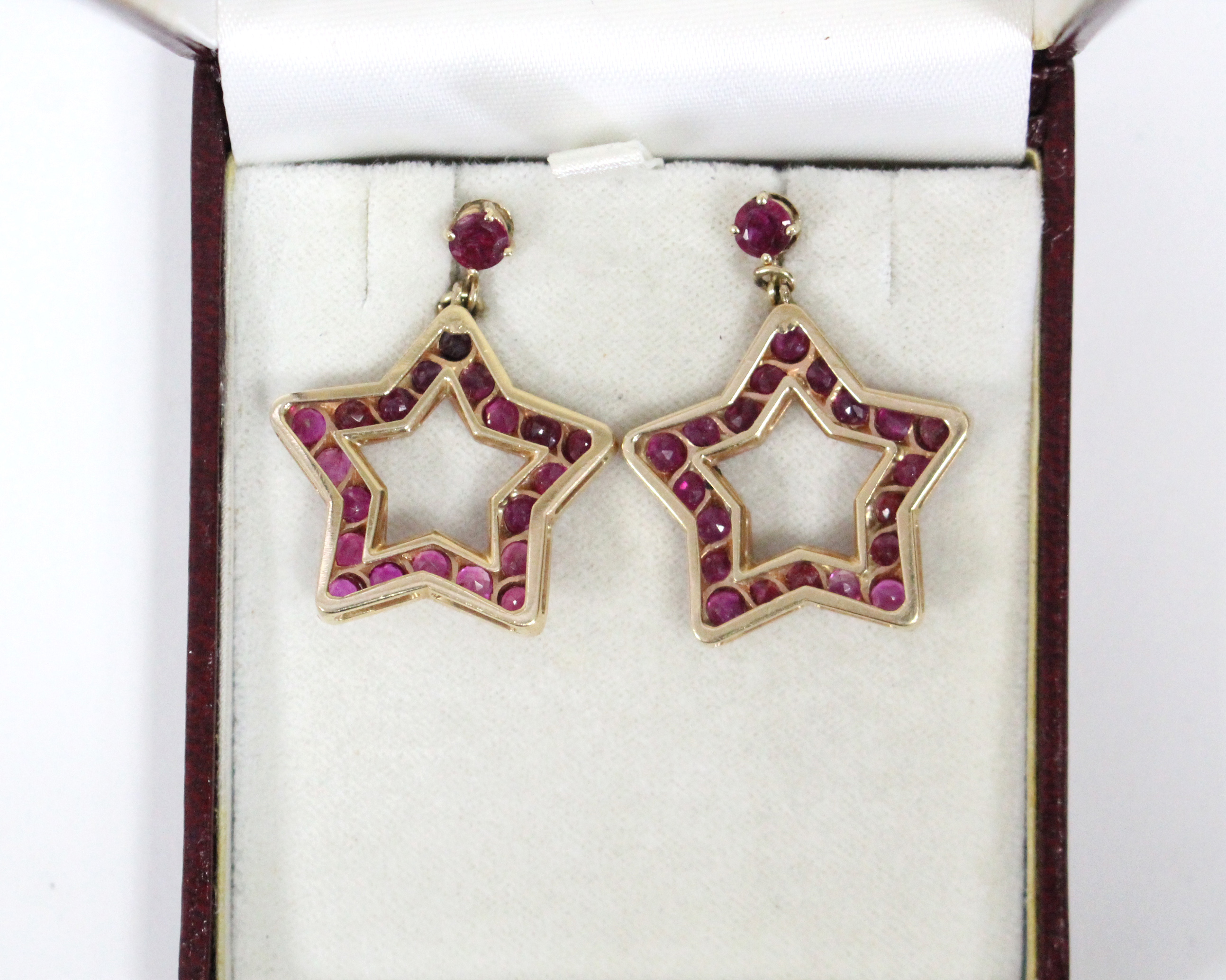 A PAIR OF RUBY PENDANT EARRINGS, each of open five-pointed star shape, set twenty round-cut stones - Image 6 of 6