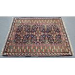 A Persian pattern Kayam rug of deep blue ground with central geometric floral design within