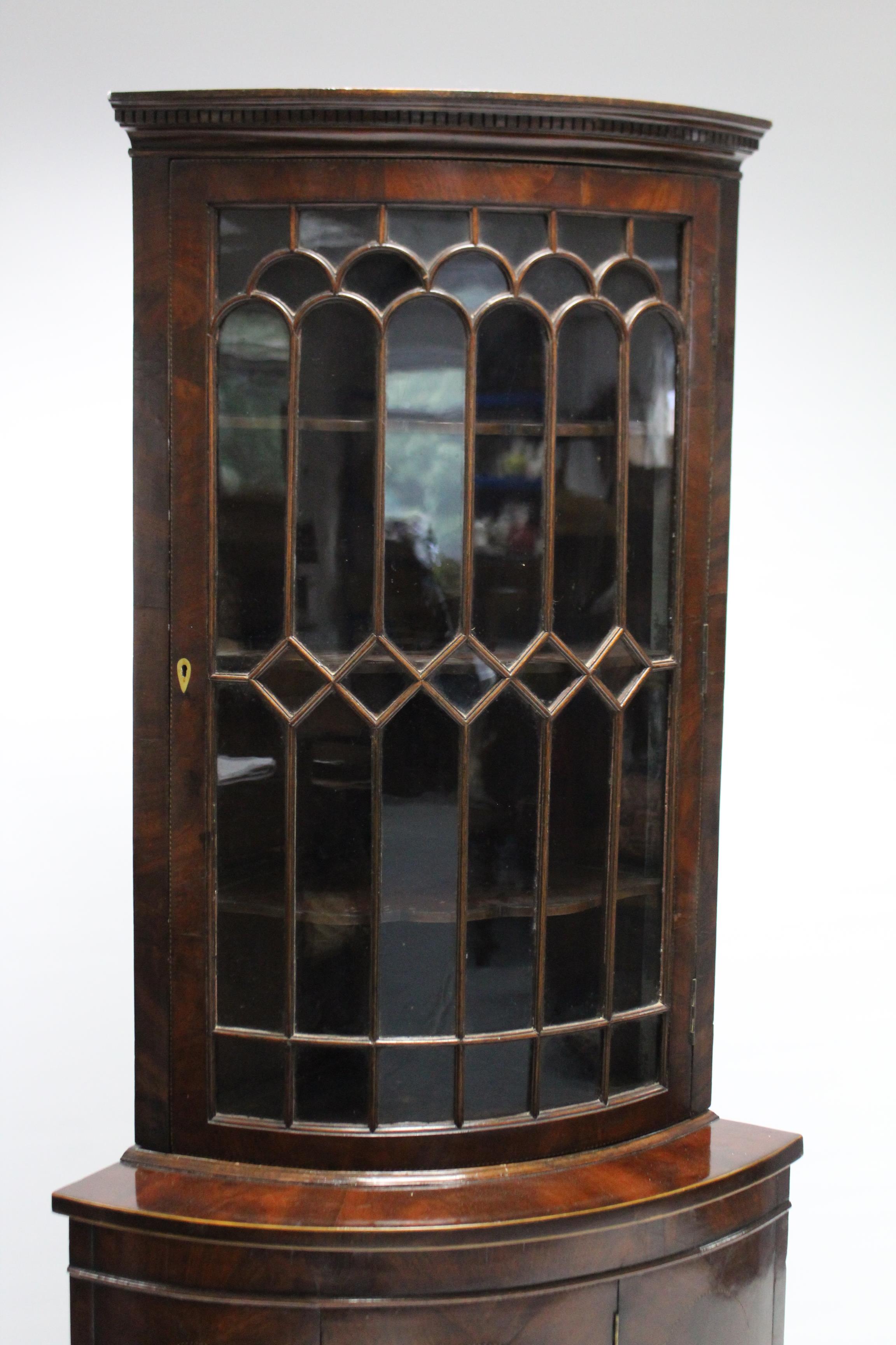An early 19th century inlaid-mahogany bow front standing corner cabinet, the upper part with moulded - Image 3 of 4
